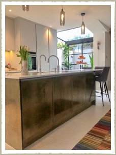 kitchen island with brass panels and doors london